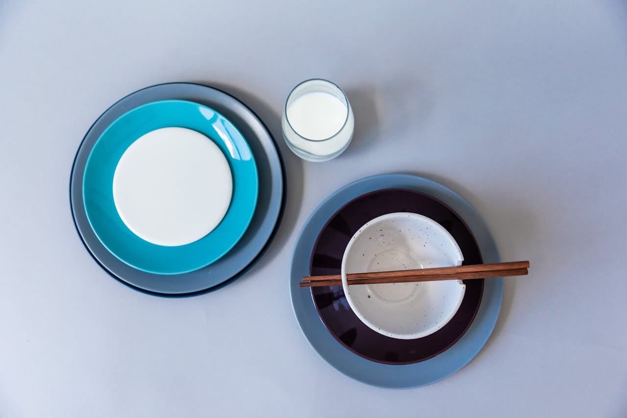 Mastering the First Impression: Your intriguing post title goes here Artistic flat lay of colorful plates with bowl and chopsticks, minimal design.